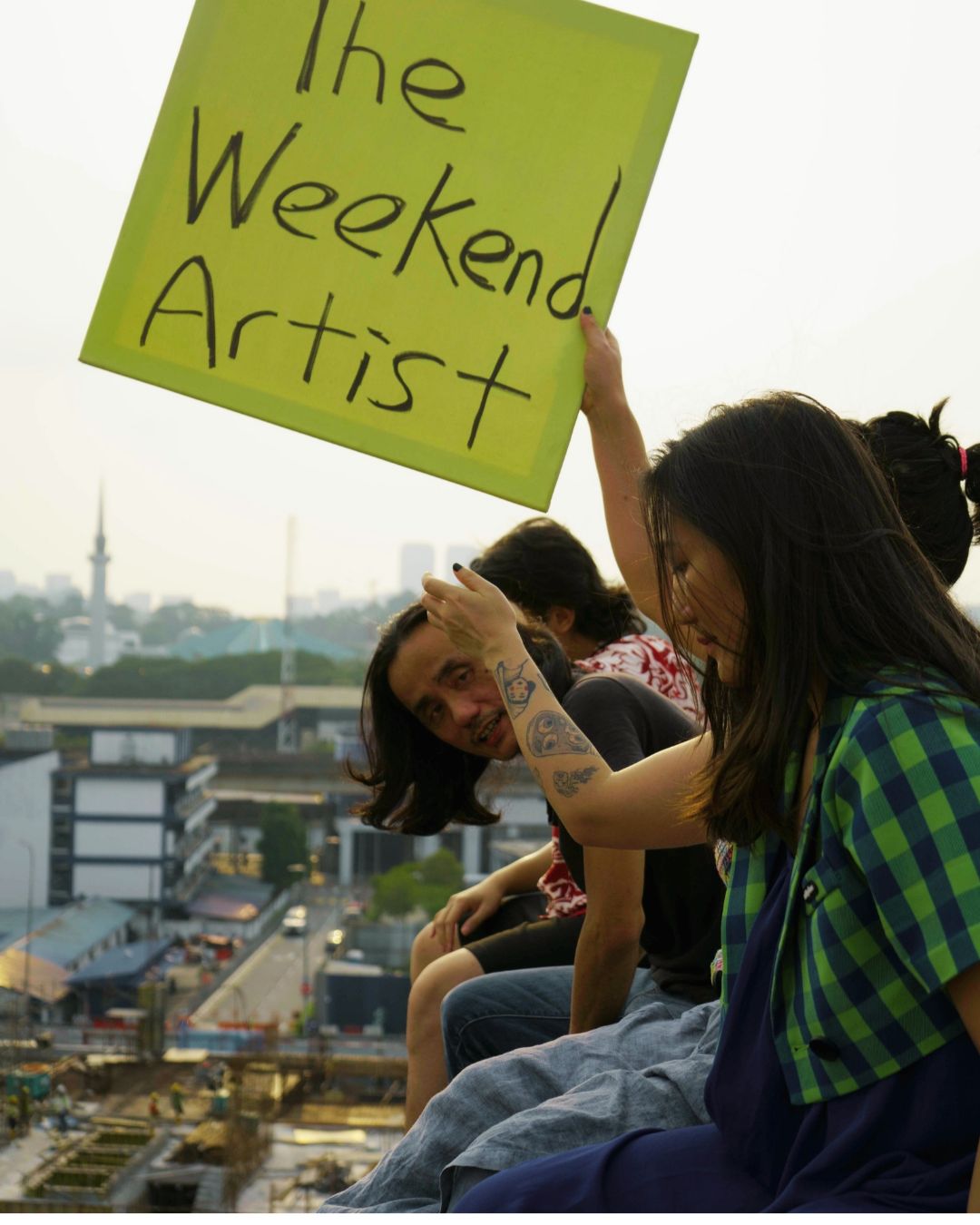 Rooftop photograph with the handmade Weekend Artist sign